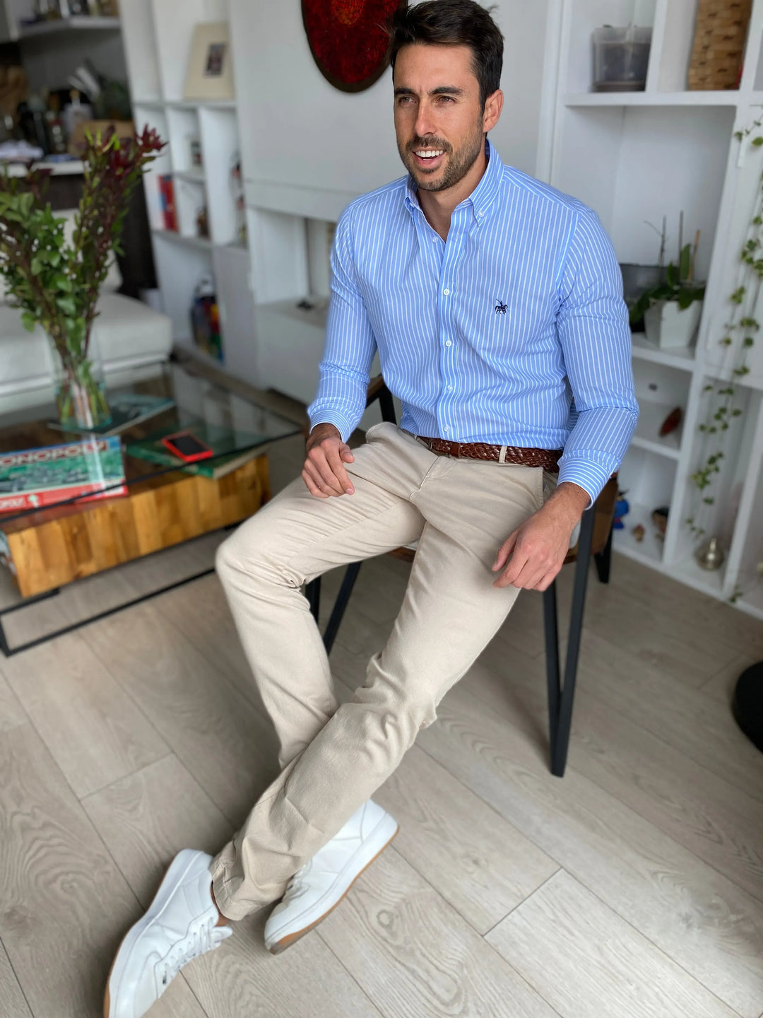 Camisa para hombre azul de rayas. Modelo masculino combinandola con un pantalón café claro y cinturón de cuero café, vistiendo un look casual.